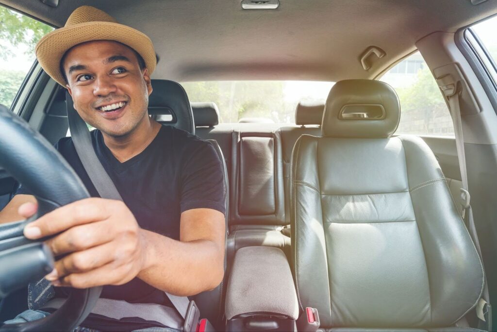 Smiling rideshare driver behind the wheel